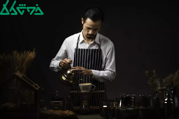 male-barista-pours-boiling-water-into-coffee-glass-making-cup-coffee-drip-filter